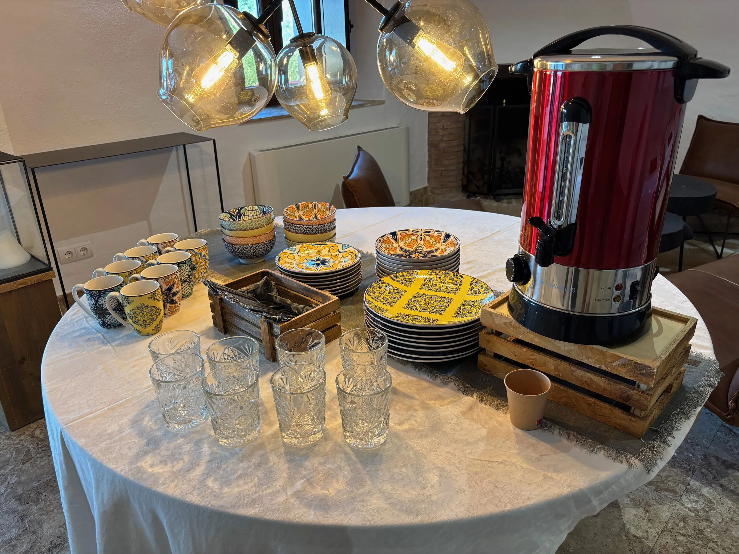 A table laid with hand-painted cups, bowls and plates ready for guests